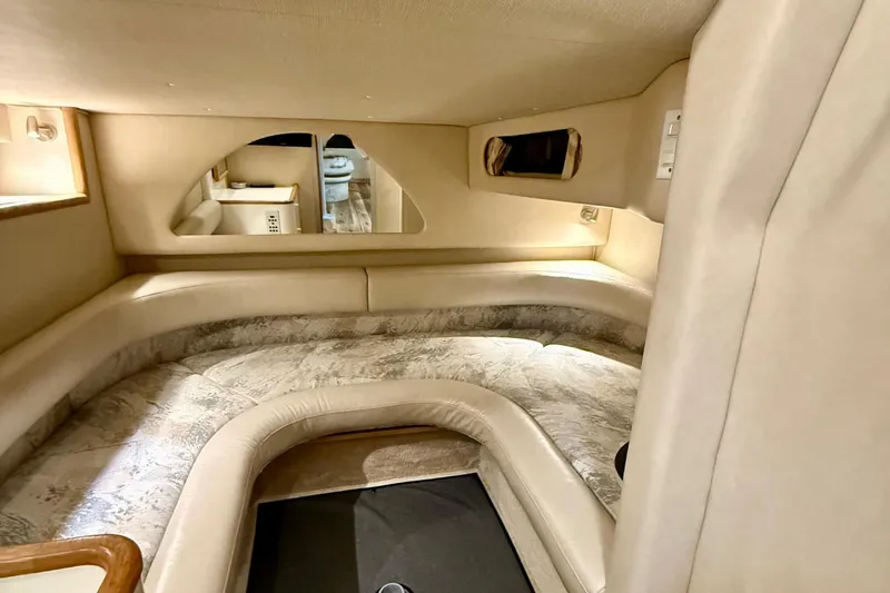 Slide: The Image of Interior cabin of 1995 Sea Ray Sundancer 370, featuring cozy seating and elegant design. - 21