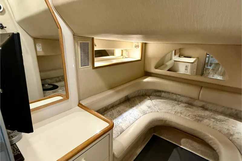 Slide: The Image of 1995 Sea Ray Sundancer 370 cabin interior with cozy seating and storage. - 22