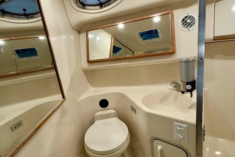 Slide: The Image of Bathroom interior of 1995 Sea Ray Sundancer 370 yacht, featuring toilet and sink. - 23