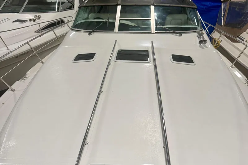 Slide: The Image of 1995 Sea Ray Sundancer 370 yacht in storage, showcasing sleek deck design. - 3