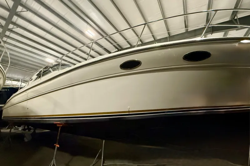 Slide: The Image of 1995 Sea Ray Sundancer 370 yacht in indoor storage, showcasing sleek design and craftsmanship. - 4