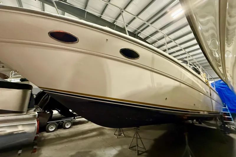 Slide: The Image of 1995 Sea Ray Sundancer 370 yacht in indoor storage, showcasing sleek design and sturdy hull. - 5