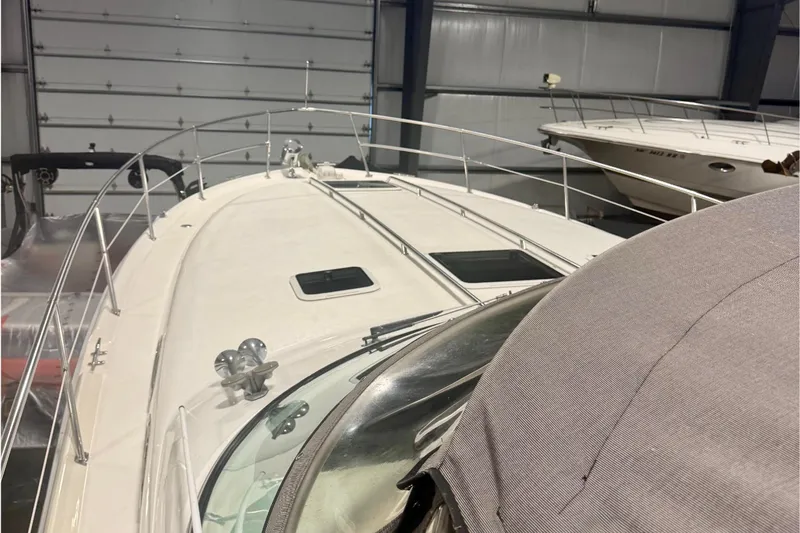 Slide: The Image of 1995 Sea Ray Sundancer 370 yacht in storage, showcasing sleek design and spacious deck. - 6