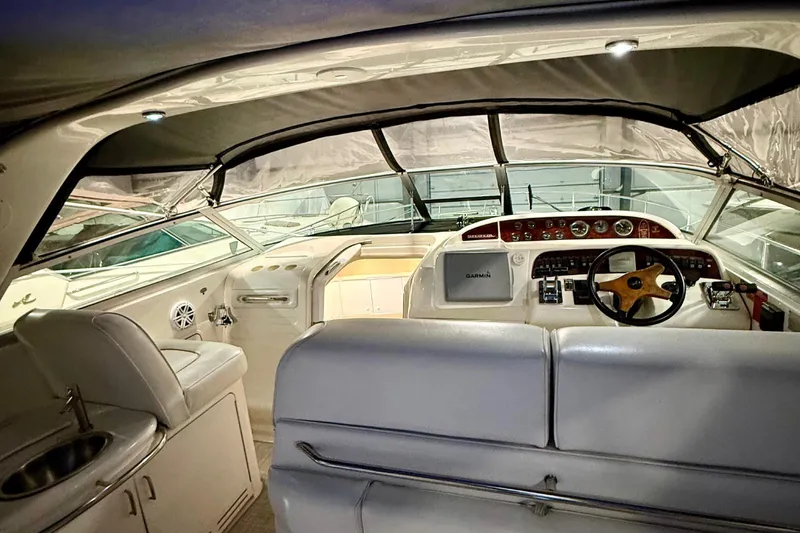 Slide: The Image of Interior view of 1995 Sea Ray Sundancer 370 yacht, featuring helm and seating area. - 9
