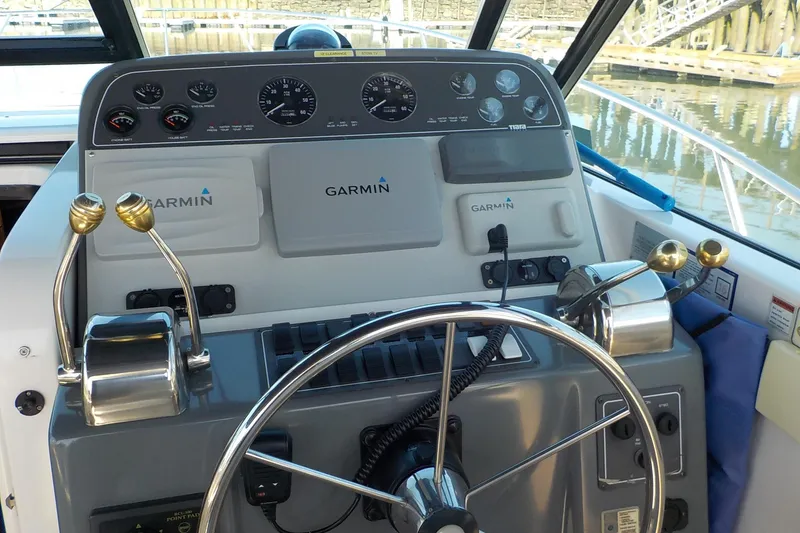Slide: The Image of Helm of 2001 Tiara Yachts 3100 Open with Garmin navigation system and dual throttle controls. - 12