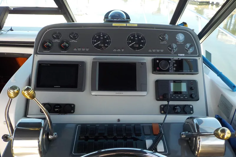 Slide: The Image of Control panel of a 2001 Tiara Yachts 3100 Open, featuring navigation and communication equipment. - 13