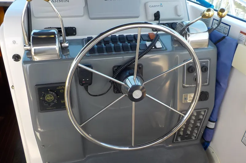 Slide: The Image of Helm of 2001 Tiara Yachts 3100 Open with steering wheel and controls. - 14