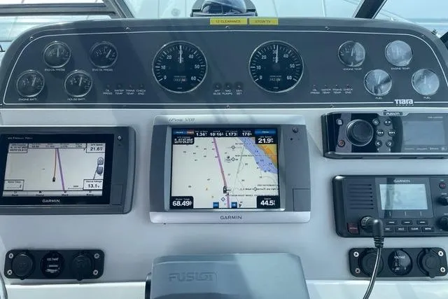 Slide: The Image of Dashboard of a 2001 Tiara Yachts 3100 Open with Garmin navigation displays. - 16