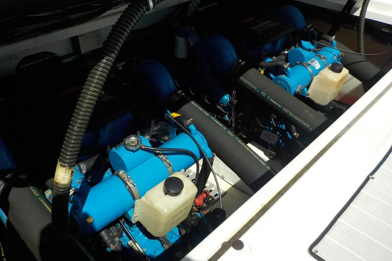 Slide: The Image of Engine compartment of a 2001 Tiara Yachts 3100 Open, showcasing dual blue marine engines. - 24