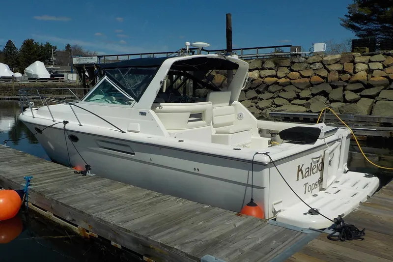 Slide: The Image of 2001 Tiara Yachts 3100 Open docked, showcasing sleek design and spacious deck. - 3