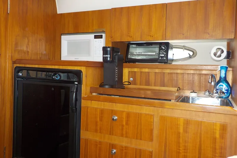 Slide: The Image of 2001 Tiara Yachts 3100 Open galley with microwave, coffee maker, and sink. - 4