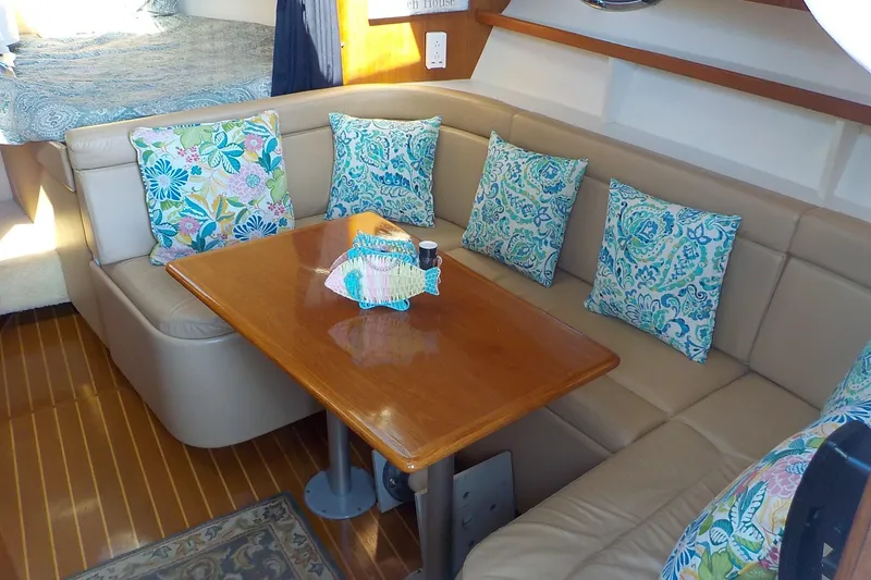 Slide: The Image of Luxurious 2001 Tiara Yachts 3100 Open interior with cozy seating and vibrant cushions. - 5