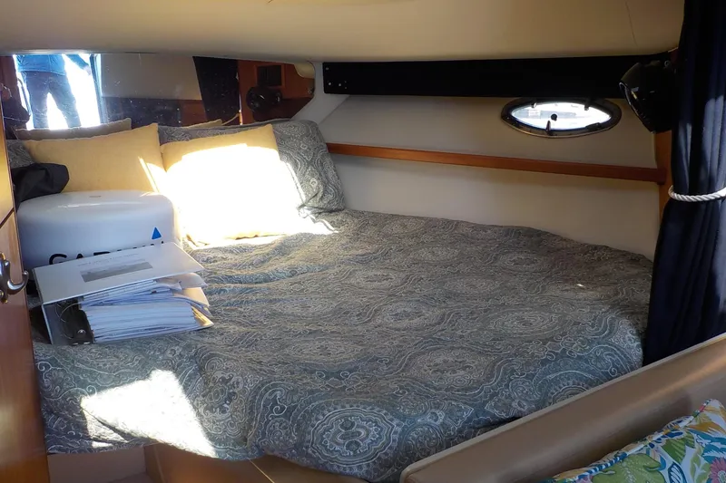 Slide: The Image of Cozy cabin interior of 2001 Tiara Yachts 3100 Open with bed and porthole. - 6