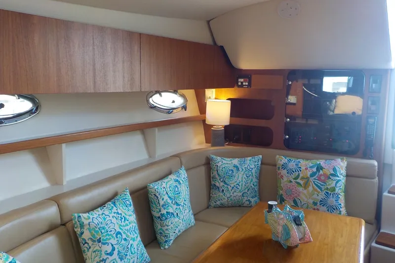 Slide: The Image of Interior of 2001 Tiara Yachts 3100 Open with cozy seating and decorative pillows. - 7