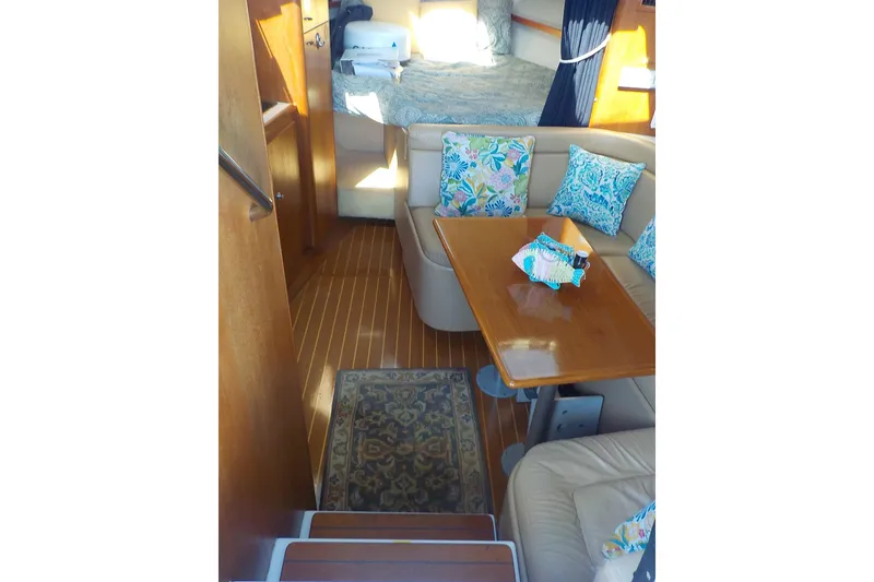 Slide: The Image of Interior of 2001 Tiara Yachts 3100 Open with cozy seating and vibrant cushions. - 8
