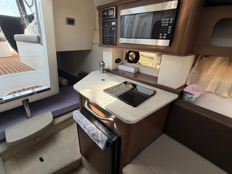 Slide: The Image of Interior of 2014 Sea Ray Sundancer 260 yacht featuring kitchenette. - 19