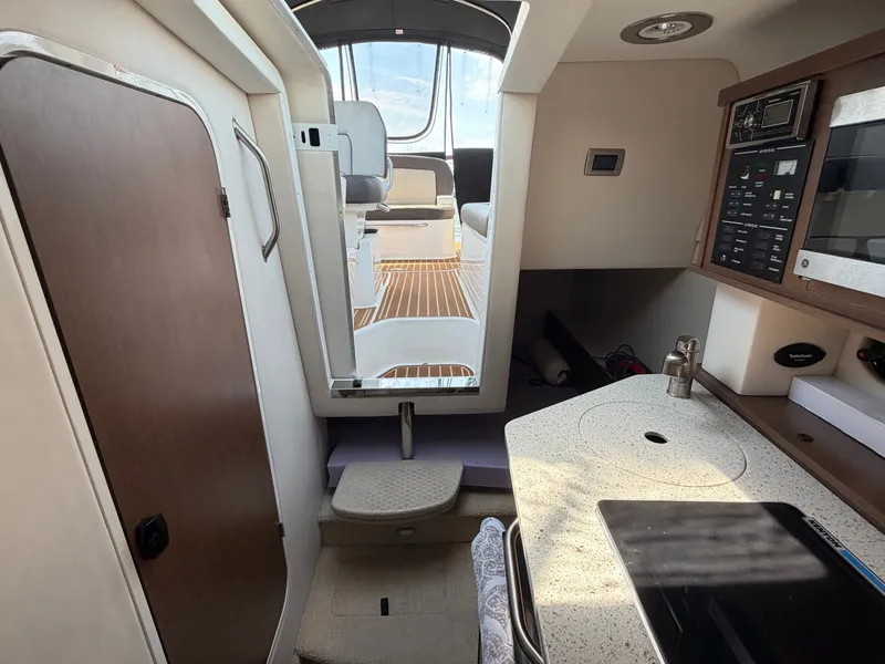 Slide: The Image of Interior of a 2014 Sea Ray Sundancer 260 yacht with modern amenities. - 20