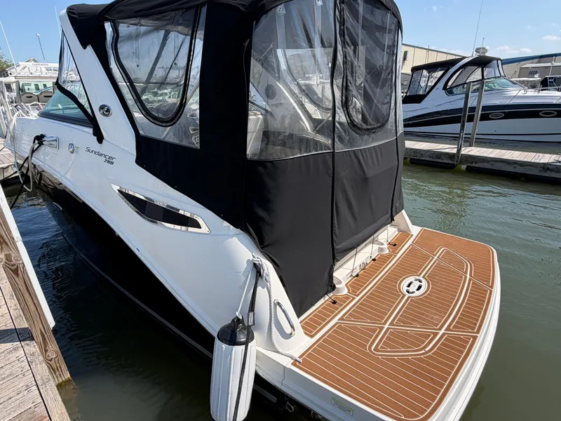 Slide: The Image of 2014 Sea Ray Sundancer 260 docked with black canopy. - 5