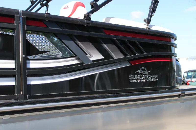 Slide: The Image of 2025 SunCatcher Select 20RC pontoon boat with sleek black and silver design. - 4