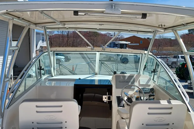 Slide: The Image of 2013 Pursuit OS 255 Offshore boat cockpit with Garmin navigation system. - 11