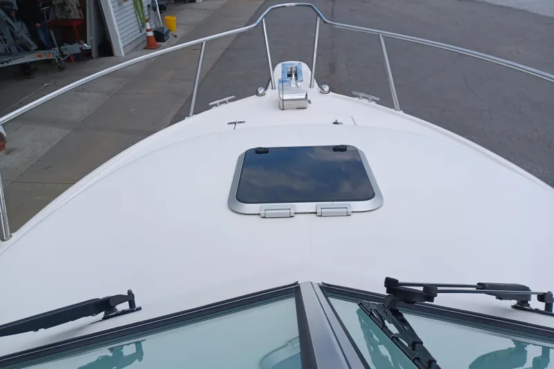 Slide: The Image of 2013 Pursuit OS 255 Offshore boat deck with hatch and railing. - 14