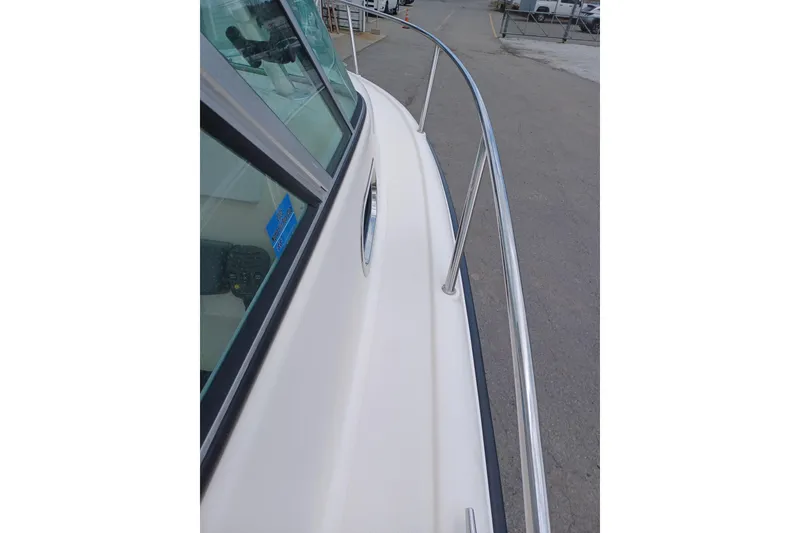 Slide: The Image of 2013 Pursuit OS 255 Offshore boat deck with stainless steel railing. - 15