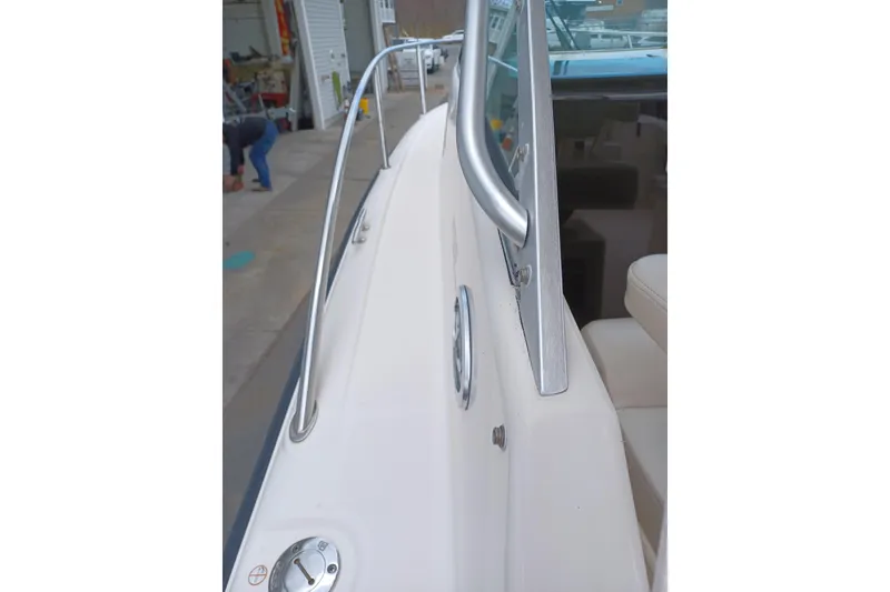 Slide: The Image of 2013 Pursuit OS 255 Offshore boat deck with railing and seating. - 16