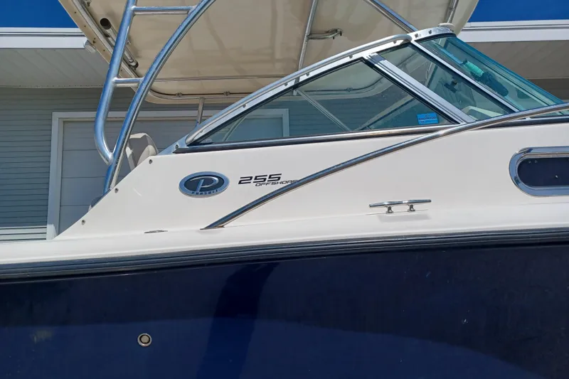 Slide: The Image of 2013 Pursuit OS 255 Offshore boat with sleek design and modern features. - 2