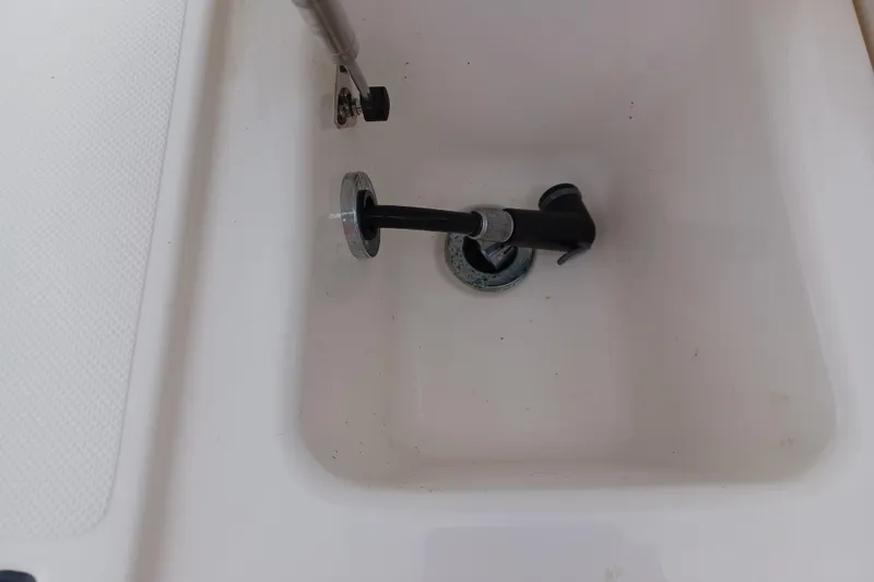 Slide: The Image of 2013 Pursuit OS 255 Offshore boat compartment with mounted hardware. - 20