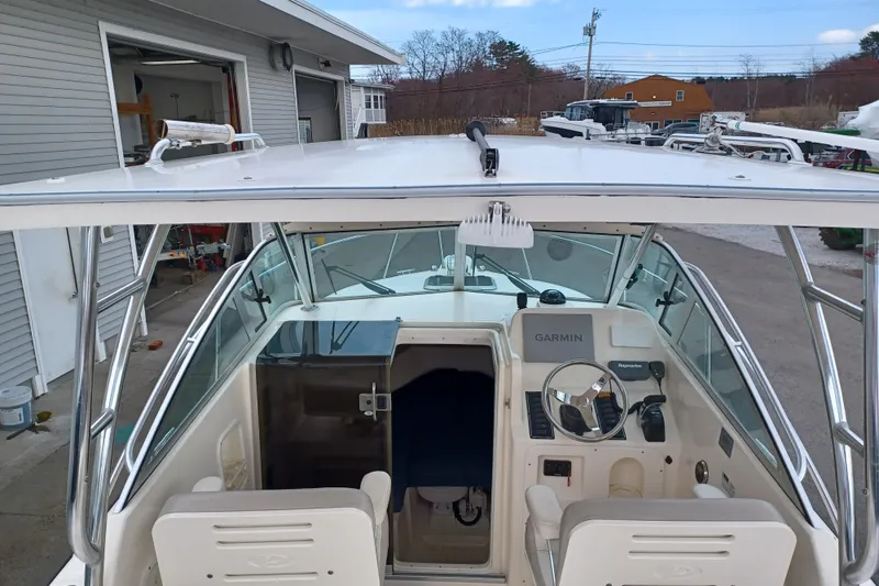 Slide: The Image of 2013 Pursuit OS 255 Offshore boat cockpit with Garmin navigation system. - 22