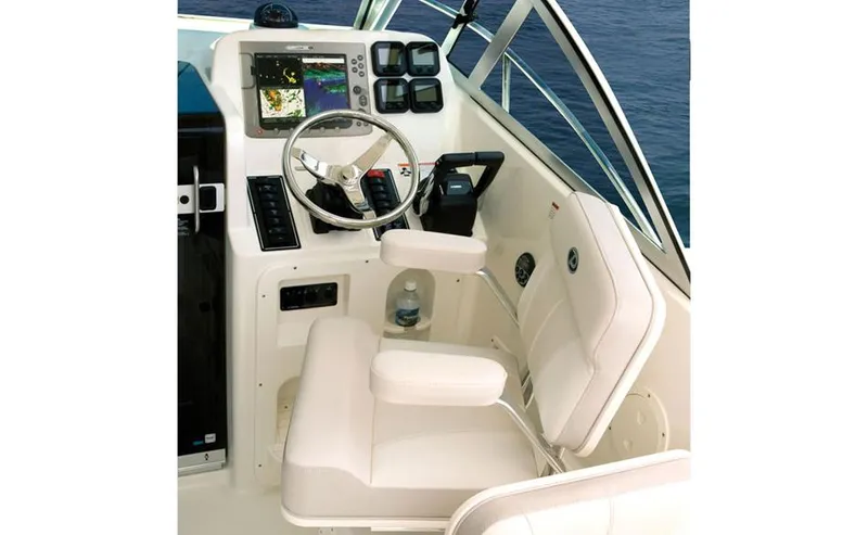 Slide: The Image of Manufacturer Provided Image: 2013 Pursuit OS 255 Offshore boat cockpit with steering wheel and navigation equipment. - 4
