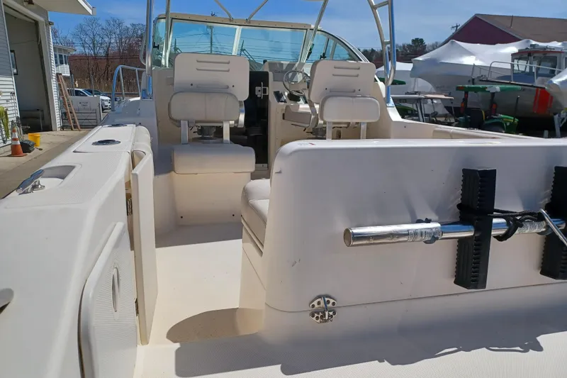 Slide: The Image of 2013 Pursuit OS 255 Offshore boat interior with seating and steering console. - 8