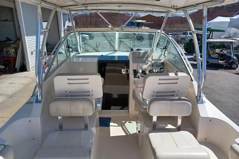 Slide: The Image of 2013 Pursuit OS 255 Offshore boat interior with helm and seating. - 9