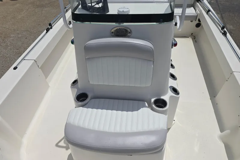 Slide: The Image of 2015 Sea Born FX22 Bay boat interior with white seating and cup holders. - 10