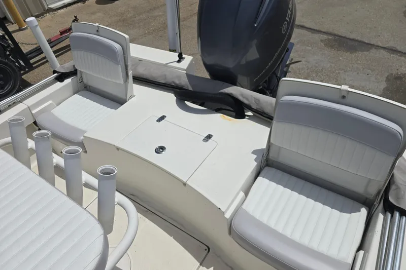 Slide: The Image of 2015 Sea Born FX22 Bay boat interior with white seating and rod holders. - 11