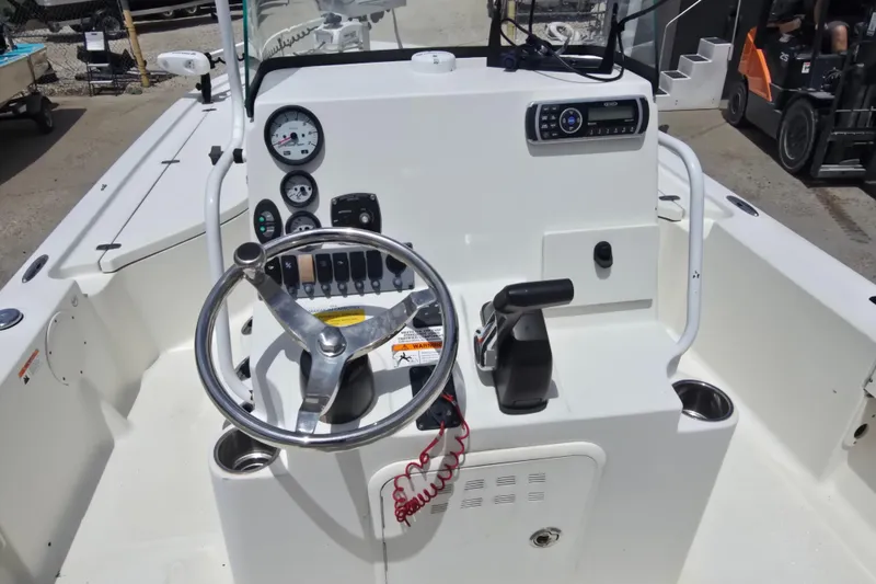 Slide: The Image of 2015 Sea Born FX22 Bay boat cockpit with steering wheel and control panel. - 12