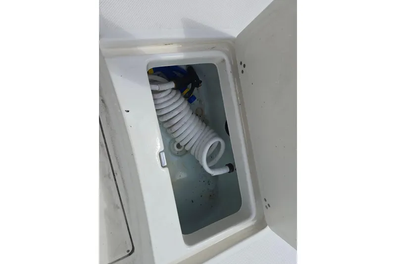Slide: The Image of Storage compartment with coiled hose in 2015 Sea Born FX22 Bay boat. - 17