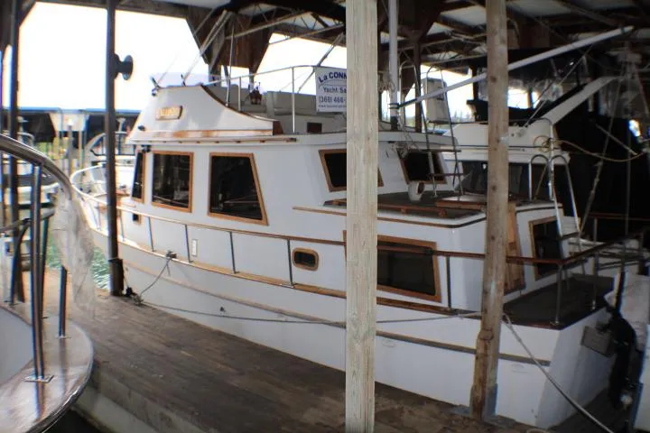 The Image of 1977 CHB Double Cabin boat docked in a covered marina. - 0