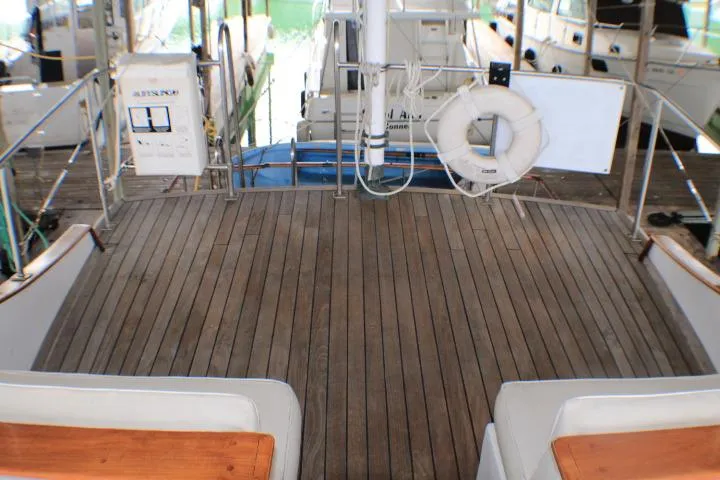 Slide: The Image of 1977 CHB Double Cabin boat deck with wooden flooring and safety equipment. - 12