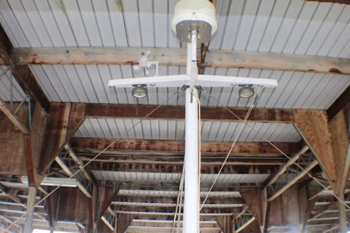 Slide: The Image of Mast of 1977 CHB Double Cabin boat under a wooden dock roof. - 13