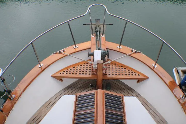 Slide: The Image of Bow view of a 1977 CHB Double Cabin boat with wooden deck details. - 14