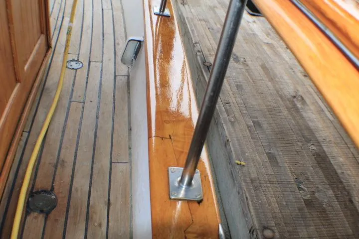 Slide: The Image of 1977 CHB Double Cabin boat deck with polished wood and metal railings. - 16