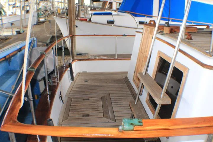Slide: The Image of 1977 CHB Double Cabin boat deck with wooden railings and hatch. - 18