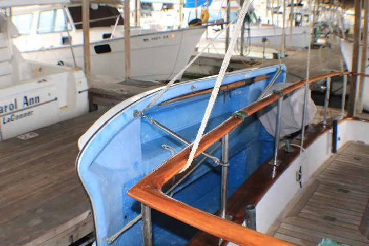 Slide: The Image of 1977 CHB Double Cabin boat docked at a marina with wooden railings. - 19