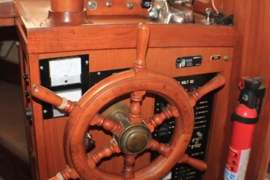 Slide: The Image of Wooden steering wheel on a 1977 CHB Double Cabin boat interior. - 21