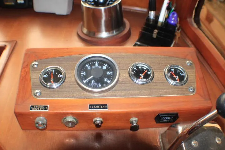 Slide: The Image of 1977 CHB Double Cabin dashboard with gauges and controls in a wooden panel. - 22