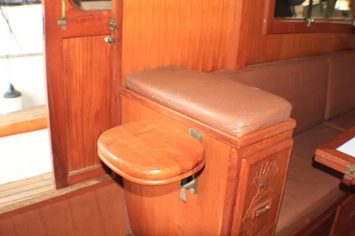 Slide: The Image of 1977 CHB Double Cabin interior with wooden seating and foldable table. - 23