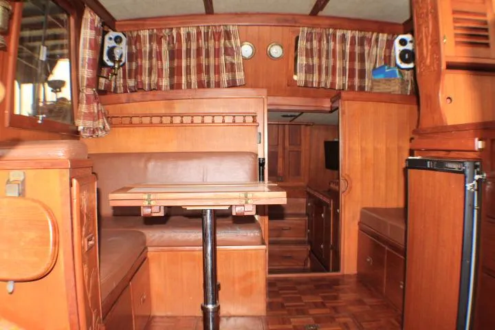 Slide: The Image of 1977 CHB Double Cabin interior with wood paneling and plaid curtains. - 24