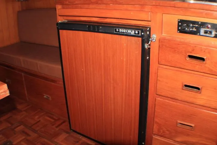 Slide: The Image of 1977 CHB Double Cabin interior with Norcold fridge and wooden cabinetry. - 29