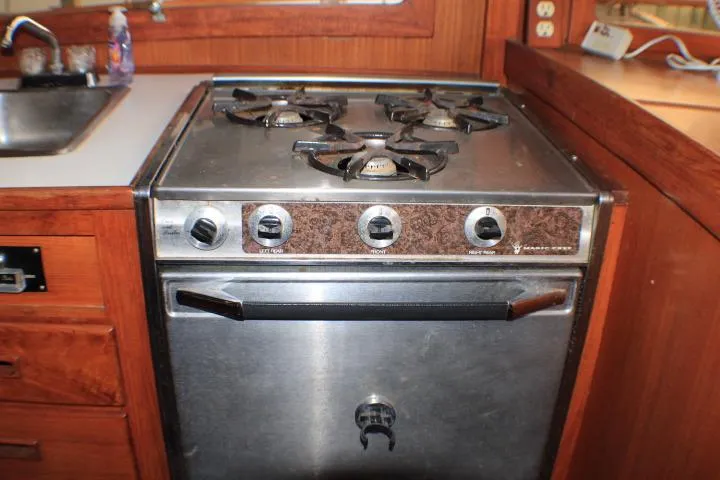 Slide: The Image of 1977 CHB Double Cabin kitchen with vintage stove and wooden cabinetry. - 31
